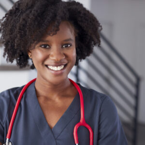 African American woman smiling with curly hair.