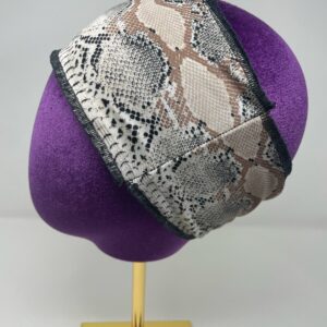 Snake pattern flat headband on mannequin head.
