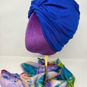 Royal blue fabric on top of a mannequin head facing side profile