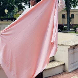 African American woman holding a large piece of fabric.